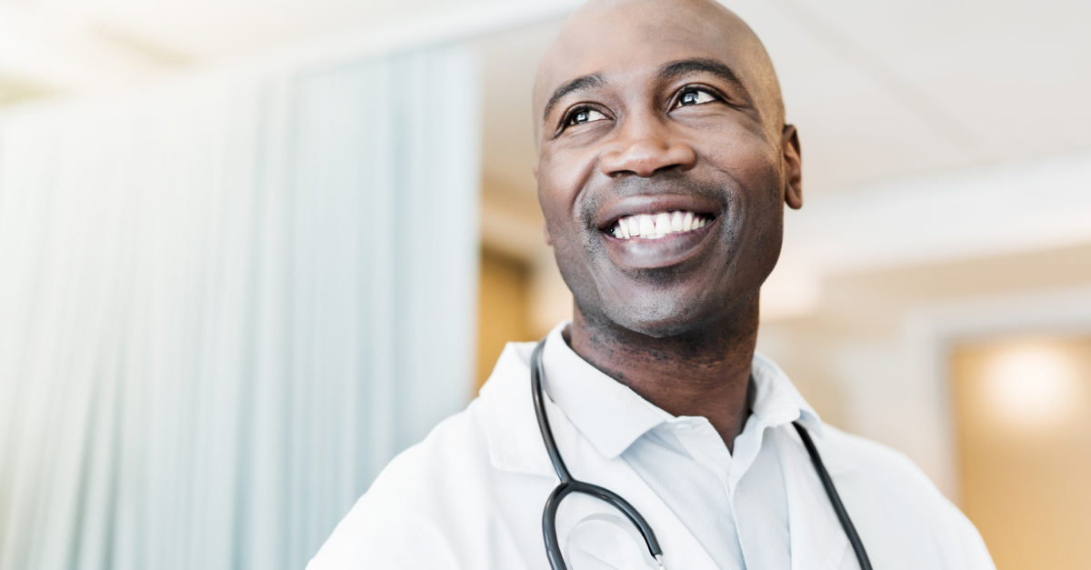 Close-up of happy confident physician looking away