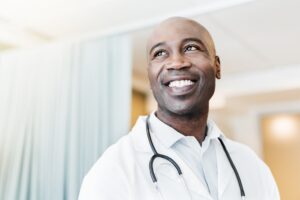 Close-up of happy confident physician looking away