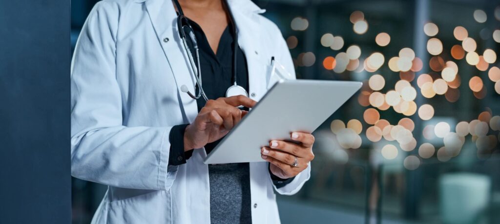Doctor viewing and scrolling through healthcare information on a tablet