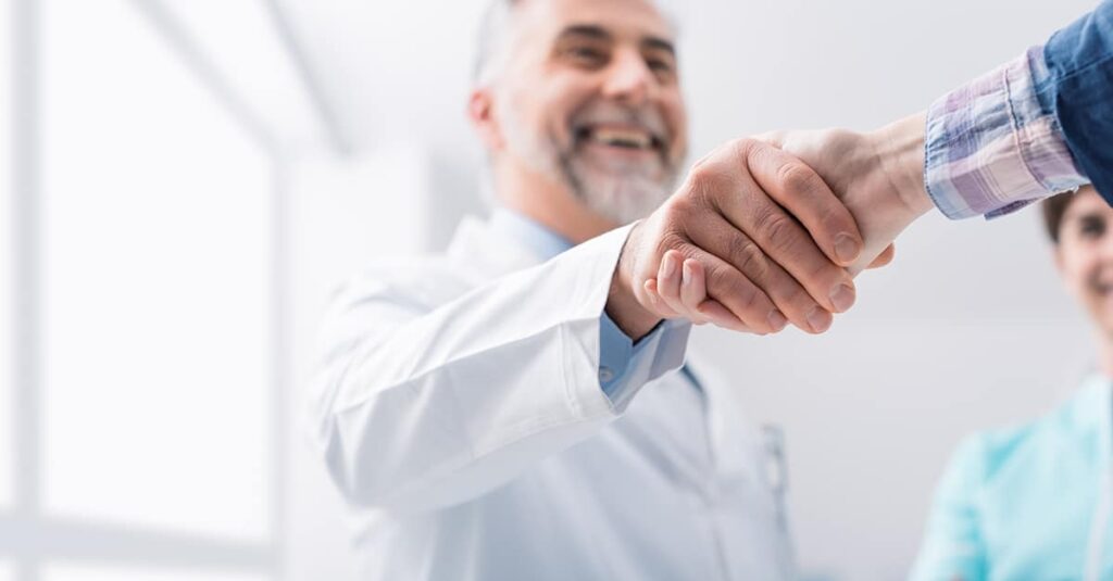 Physician from referral shaking patient's hand