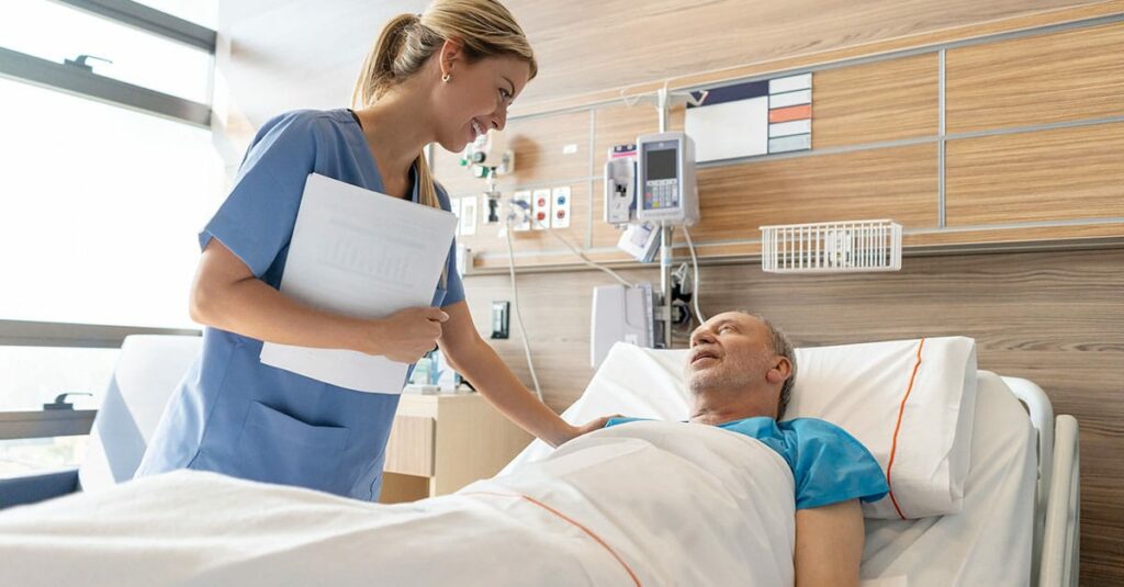 Doctor treating patient in hospital bed
