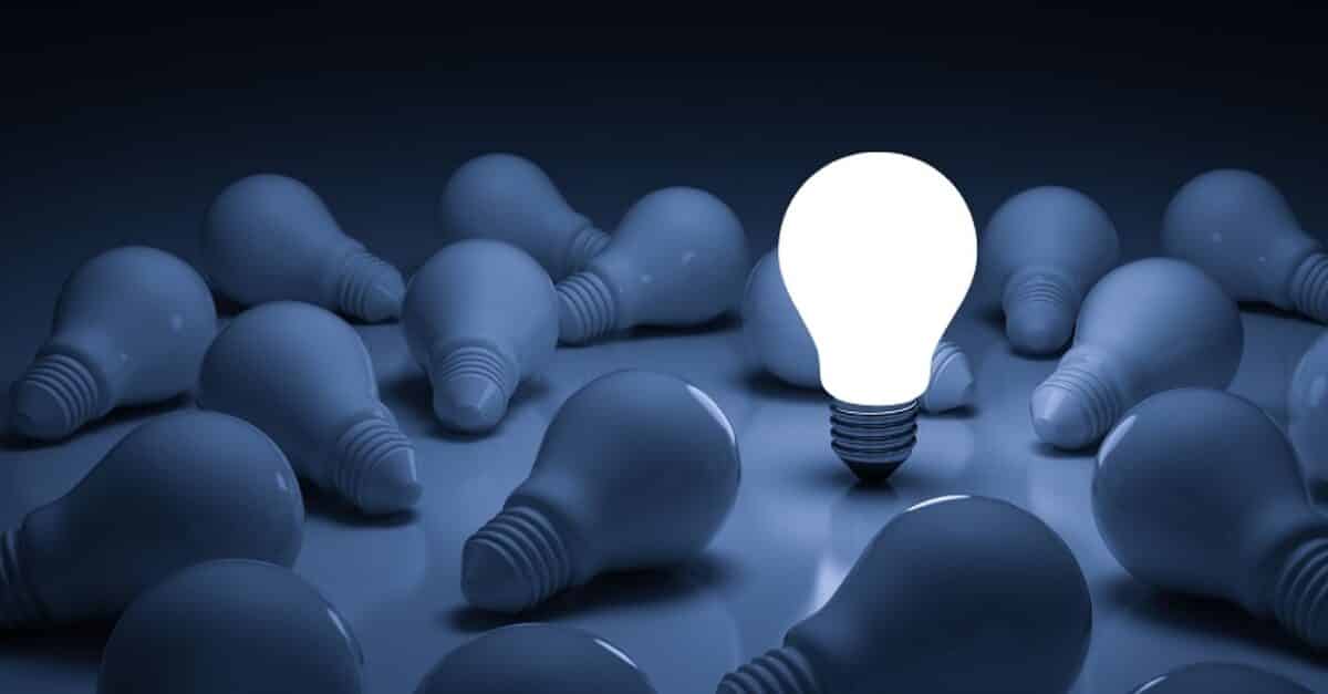 One glowing light bulb standing out from the unlit incandescent bulbs with reflection , leadership and different creative idea concept. 3D rendering.