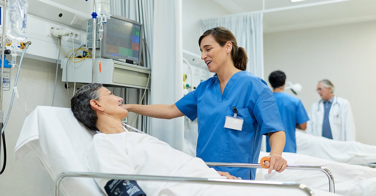 Nurse comforting a patient before a surgical procedure.