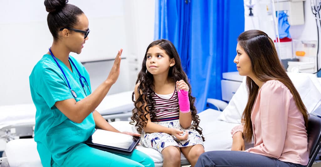pediatrician speaking with patient and parent